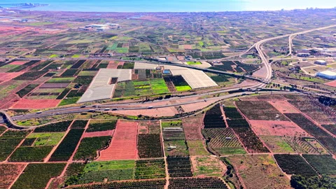 Aerial view of vast agricultural fields and highway intersection Stock Footage 330489705