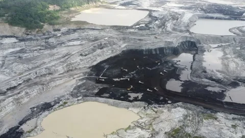 Aerial view of a vast coal mine with coal trucks moving around Stock Footage 287922822
