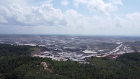 Aerial view of a vast coal mine with coal trucks moving around Stock Footage 287929802