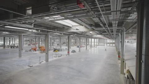 Aerial view of vast empty industrial warehouse interior during final stage .. Stock Footage 337477504