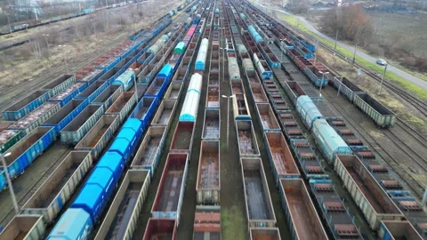 Aerial view of a vast freight train yard showcasing rows of colorful train cars Stock Footage 323183366