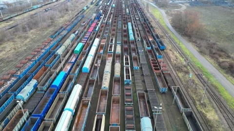 Aerial view of a vast freight train yard showcasing rows of colorful train cars Stock Footage 335886490