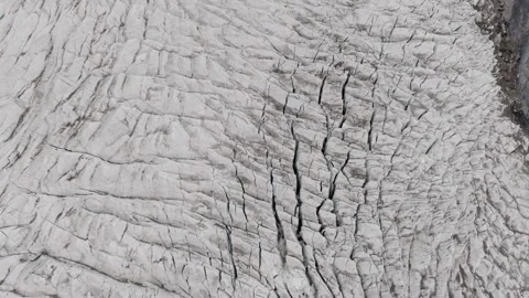 Aerial view of a vast glacier in a remote mountainous region, highlighting the Stock Footage 314457433