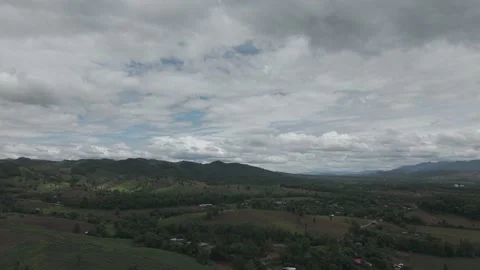 Aerial View of Vast Mountain Valley With Big Sky, Rolling Clouds and Rural .. Stock Footage 337393559