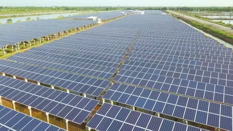 Aerial view of a vast solar panel farm generating clean energy Video stock 312432937