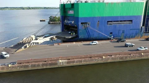 Aerial View of Vehicles Being Loaded and Unloaded from a Vehicle Carrier Ship Stock Footage 134222089