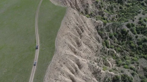 Aerial view, vehicles going up the hill with surreal landscape in Vashlovani Video stock 238479625