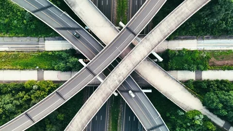 Aerial view of vehicles moving through layered highway overpasses... Видео 340657952