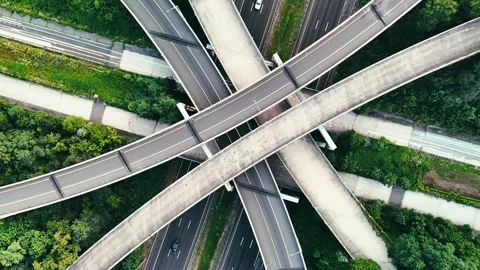 Aerial view of vehicles moving through layered highway overpasses... Stockbeeldmateriaal 340657955