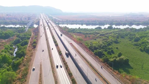 Aerial view of vehicles traverse on a parallel expressway Stock Footage 299784447