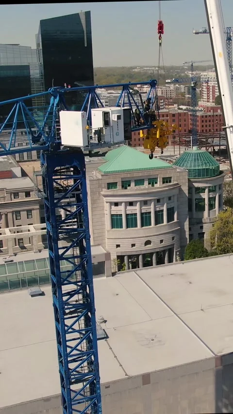 Aerial View Vertical Pull Back of Workers on Blue Tower Crane Jib Stock Footage 331366437