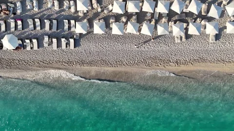 Aerial view of a vibrant beach resort with sun loungers and umbrellas. People Stockbeeldmateriaal 341126691