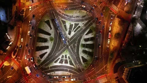 Aerial view of vibrant city intersection at night with dynamic traffic flow Stock Footage 321562369