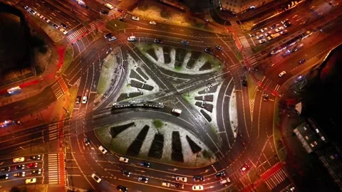 Aerial view of vibrant city intersection at night with dynamic traffic flow Stock Footage 335888823