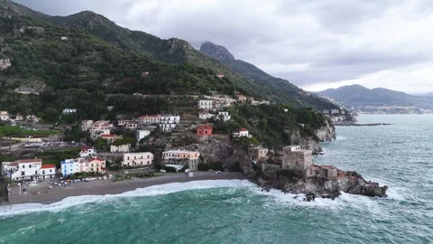 Aerial view of the vibrant Erchie beach with its historic coastal tower, set Stock Footage 325389460