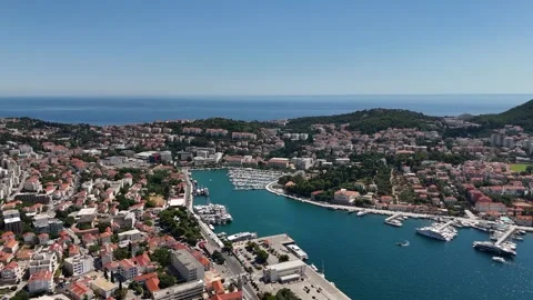 Aerial view of a vibrant harbor surrounded by coastal cityscape Stock-Footage 345118179