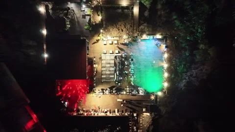 Aerial view of vibrant night scene at hotel resort with illuminated pool Stockbeeldmateriaal 344558341