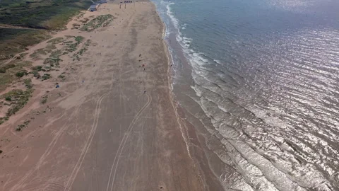 Aerial view video clip of Katwijk aan Zee sandy shoreline, glistening North Stock Footage 341699412