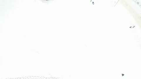 Aerial view video of some unrecognizable people going on the snow covered ski Stock Footage 103848657