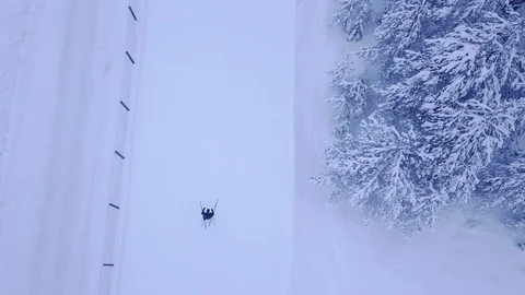 Aerial view video of unrecognizable man or woman skier training on snow covered Stock Footage 103201277