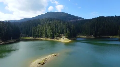 Aerial view. View from above. View of mountain lake near the forest. Blue clouds Stock Footage 73802850