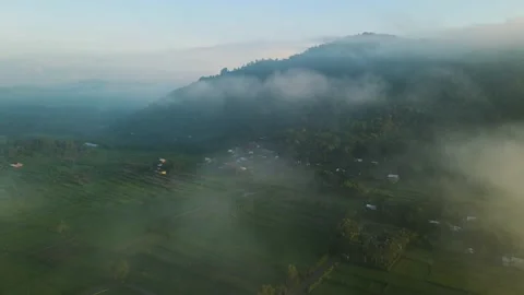 Aerial view, a view of rice fields and hills shrouded in mist in the morning Stock Footage 188395017