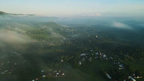 Aerial view, a view of rice fields and hills shrouded in mist in the morning Stock Footage 188396420