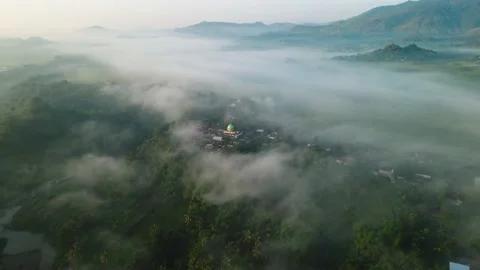 Aerial view, a view of rice fields and hills shrouded in mist in the morning Stock Footage 196261448