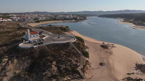 Aerial view of Vila Nova de Milfontes lighthouse and viewpoint above the beach Stock Footage 346374148