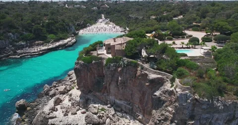 Aerial view of villa on cliff overlooking Cala Llombards beach Mallorca Stock-Footage 333646482
