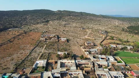 Aerial view of village between hills in Chakwal, Pakistan on February 22, 2025. Stock Footage 308210053