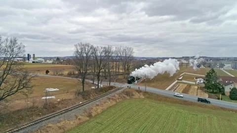 Aerial view of vintage steam engine train crossing rural road in lancaster .. Stock Footage 337389037