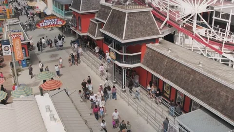 Aerial view of visitors walking through Santa Cruz Beach Boardwalk amusement Stock Footage 340115781