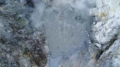 Aerial view of Volcanic Activity Boiling Geothermal Mud Pot In Crater Of Acti Stock Footage 124875281