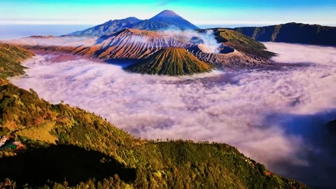 Aerial view of volcanic mountain peaks rising above sea of clouds in East Java 動画素材 346262859
