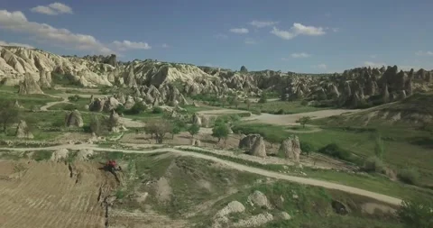 Aerial View of Volcanic Rock Formations and Agricultural Fields in Cappadocia Stock Footage 338314613