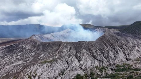 Aerial View of Volcanic Slopes and Smoking Mount Bromo Crater East Java Indonesi Video stock 344892261