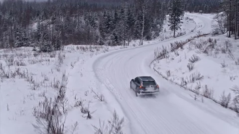 Aerial view of Volvo v90 cross country car is driving on the snow road. Beautifu Stock Footage