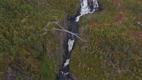 Aerial view of Voringfossen cascade cutting through rugged Vestland, Norway Stock Footage 321029294