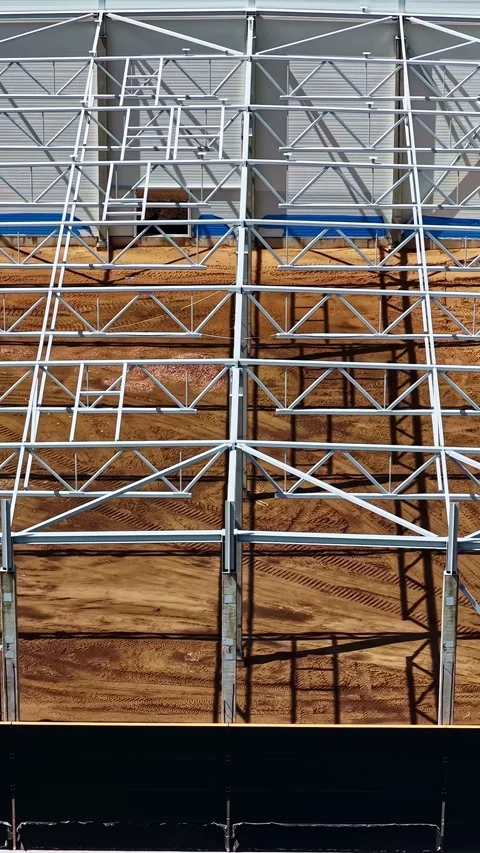 Aerial view of a warehouse construction site with steel frame and concrete Stock Footage 343820895