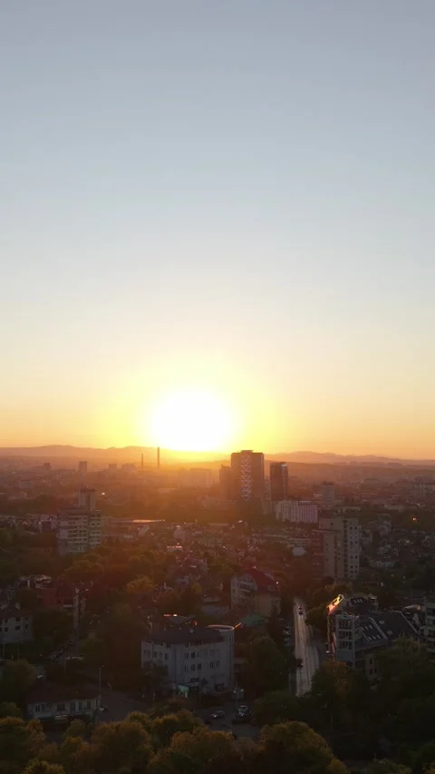 Aerial View of Warm Sunset Light Over Sofia City and Surrounding Urban Landscape Stock Footage 336098493