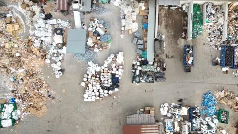 Aerial view of waste sorting and recycling process showing piles of garbage Video stock 331376614