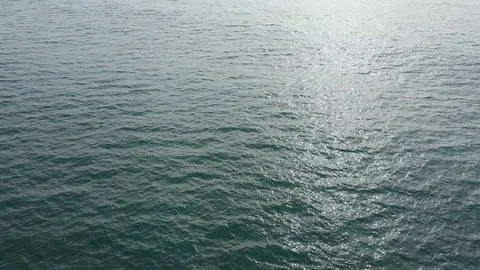 Aerial view of water backlit at sunset Stock Footage 101562739