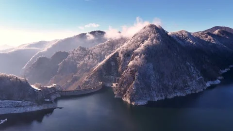 Aerial view of Water dam between snow covered mountains. Stock Footage 262566731