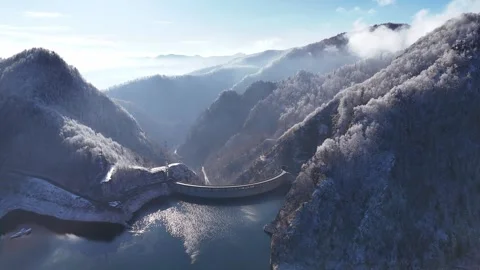 Aerial view of Water dam between snow covered mountains. Stock Footage 262572734