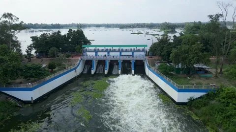 Aerial view of water discharging through river sluice gate spillway, drone .. Video stock 344821103