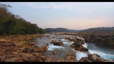 Aerial view of water flowing over rocky riverbed in Haflong Assam Stock Footage 339268355