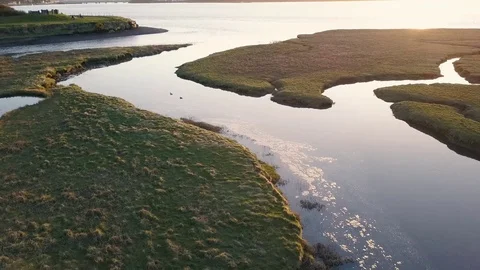 Aerial View of Water Flowing Through Marshlands at High Tide Video stock 73559093