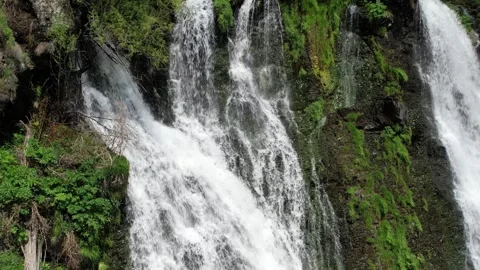 Aerial view of water streams running down mossy cliffs, Shaki waterfall Stock Footage 342843218