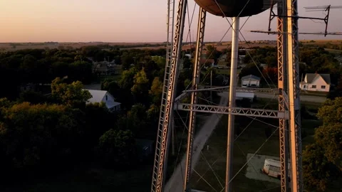 Aerial view of the water tower and town at dusk 스톡 동영상 345531660